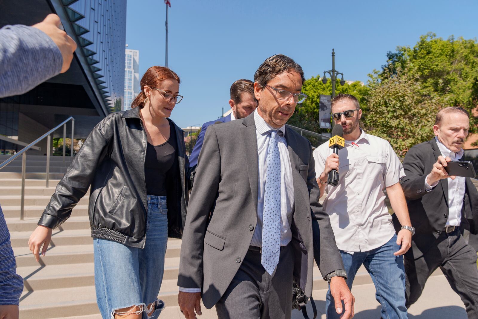 Dr. Mark Chavez, a physician from San Diego, who is charged in connection with Matthew Perry's fatal overdose, center, walks out of the United States Courthouse after pleading guilty to conspiring to distribute the surgical anesthetic ketamine in Los Angeles on Wednesday, Oct. 2, 2024. (AP Photo/Damian Dovarganes)