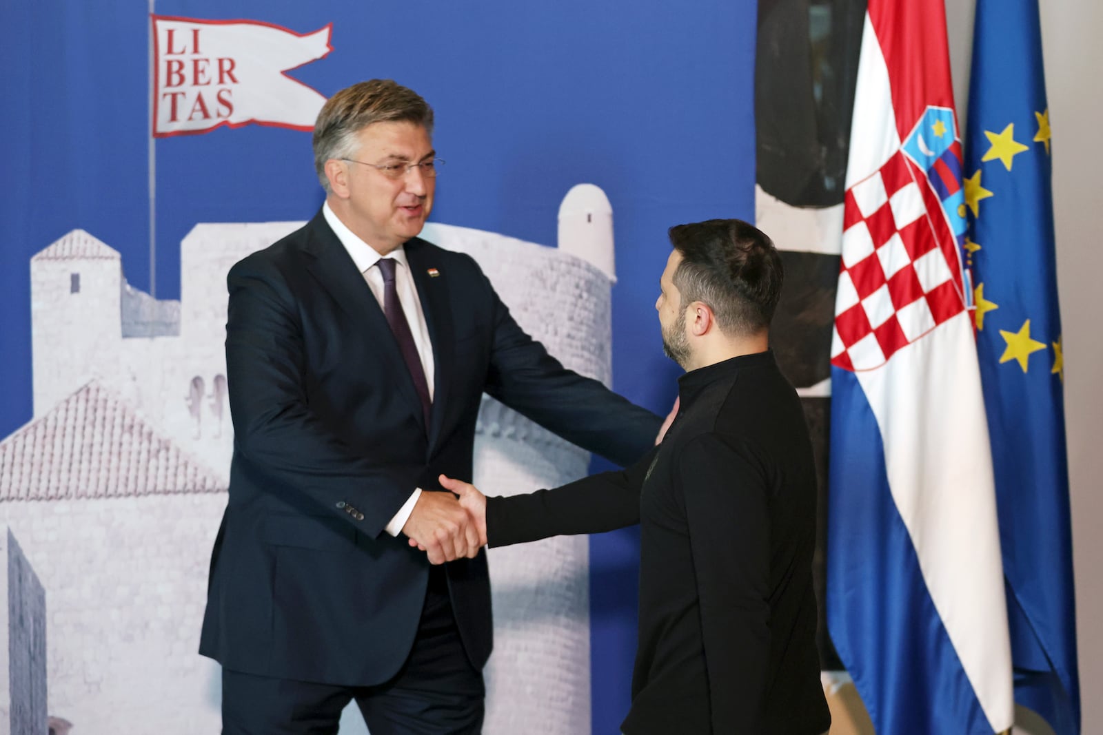 Ukrainian President Volodymyr Zelenskyy, right, is welcomed by Croatian Prime Minister Andrej Plenkovic at the Southeast Europe Croatia Ukraine summit in Dubrovnik, Croatia, Wednesday, Oct. 9, 2024. (Damir Sencar/Pool Photo via AP)