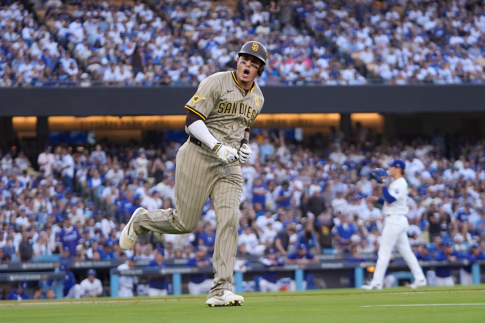 San Diego Padres' Manny Machado celebrates as he rounds first base after hitting a two-run home run during the first inning in Game 1 of baseball's NL Division Series against the Los Angeles Dodgers, Saturday, Oct. 5, 2024, in Los Angeles. (AP Photo/Mark J. Terrill)