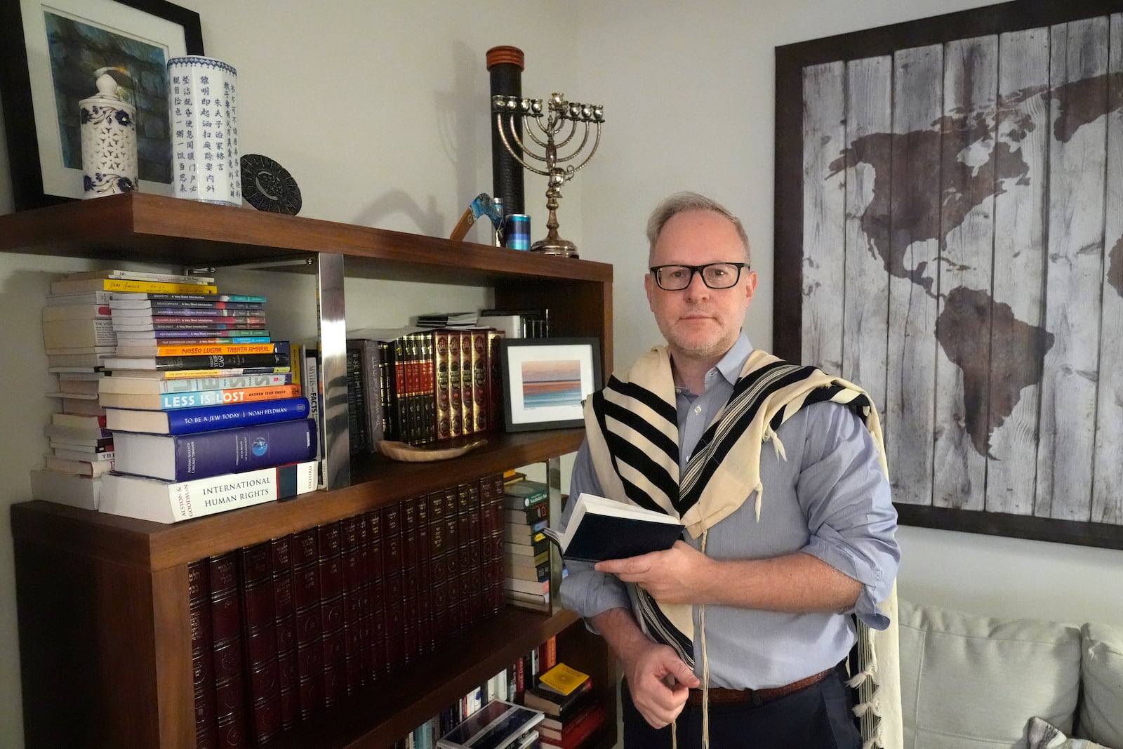 Daniel Gammerman poses for a photo in his home where he plans to worship privately during the Jewish High Holy Days, Thursday, Sept. 26, 2024, in Miami. (AP Photo/Wilfredo Lee)