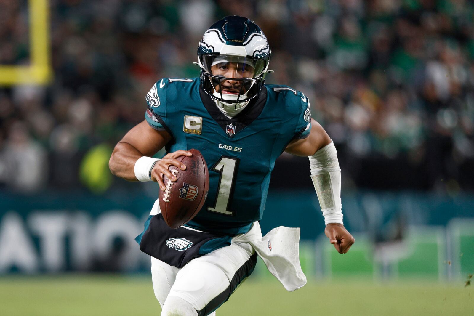 Philadelphia Eagles quarterback Jalen Hurts (1) runs with the ball during the second half of an NFL football game against the Washington Commanders Thursday, Nov. 14, 2024, in Philadelphia. (AP Photo/Laurence Kesterson)