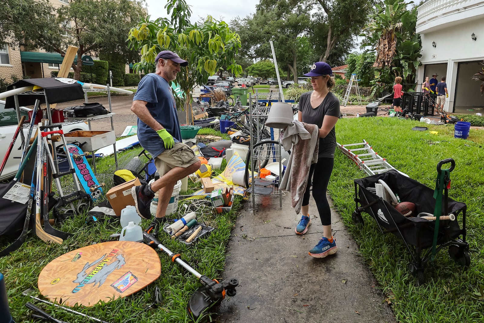 Ellie Moss, right, along with family and friends cleans contents of her home after flooding from Hurricane Helene on Davis Island Saturday, Sept. 28, 2024, in Tampa, Fla. (AP Photo/Mike Carlson)