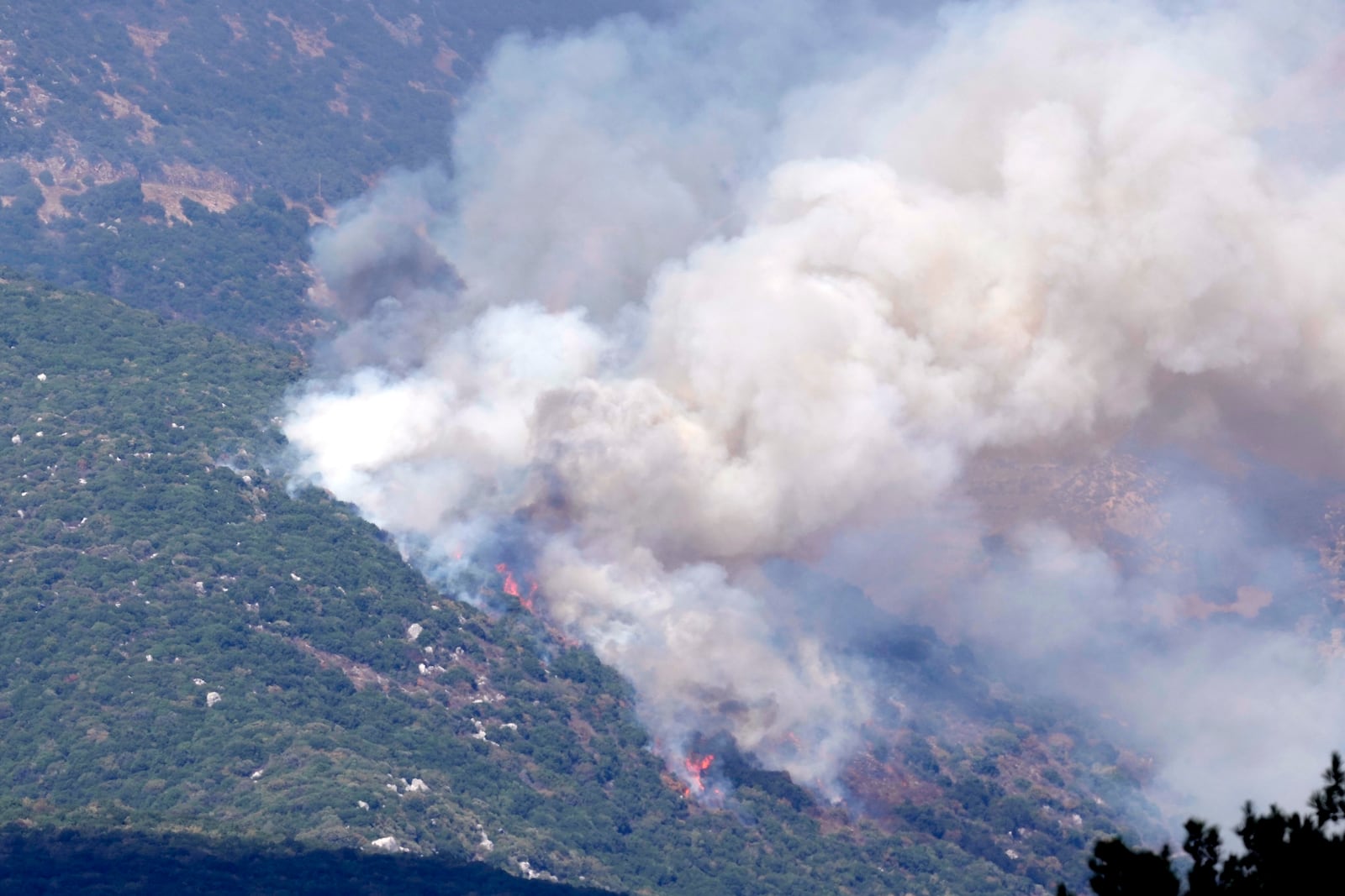 Smoke rises from Israeli shelling in Jabal al-Rihan, seen from the southern Lebanese town of Marjayoun, Saturday, Sept. 21, 2024. (AP Photo/Hussein Malla)