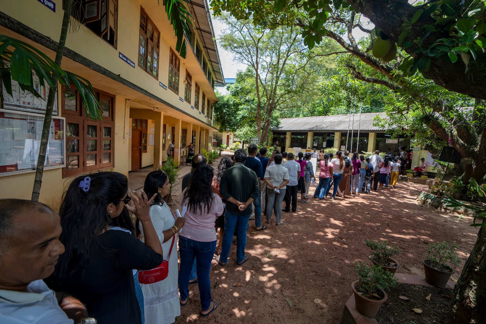 People wait in a queue to cast their votes at a polling center during the presidential election on the outskirts of Colombo , Sri Lanka Saturday, Sept. 21, 2024.(AP Photo/Rajesh Kumar Singh)