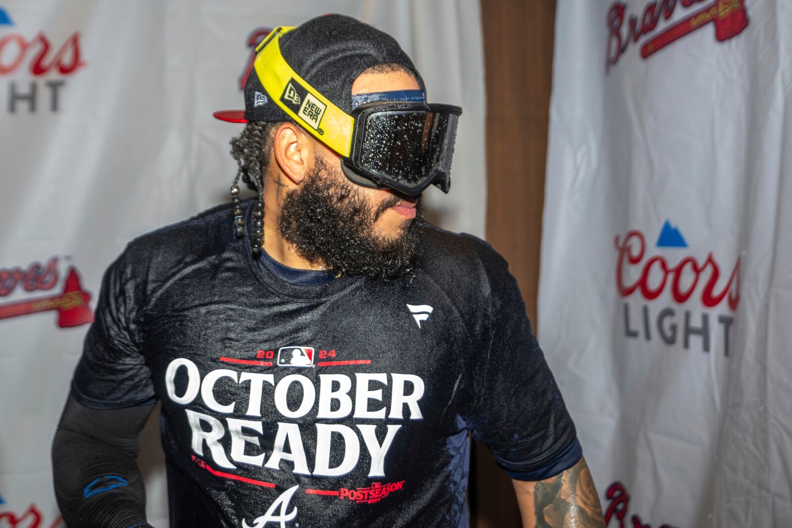 Atlanta Braves pitcher Daysbel Hernández celebrates in the locker room after clinching a wild-card playoff berth after the second baseball game of a doubleheader against the New York Mets, Monday, Sept. 30, 2024, in Atlanta. (AP Photo/Jason Allen)