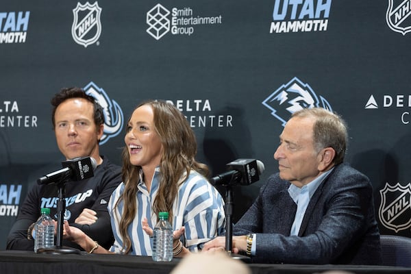 Chairman of Smith Entertainment Group Ryan Smith and co-founder Ashley Smith join NHL Commissioner Gary Bettman, from left, as they announce the Utah Mammoth as the new name and branding identity of Utah's NHL franchise, Wednesday, May 7, 2025, in Salt Lake City. (AP Photo/Melissa Majchrzak)