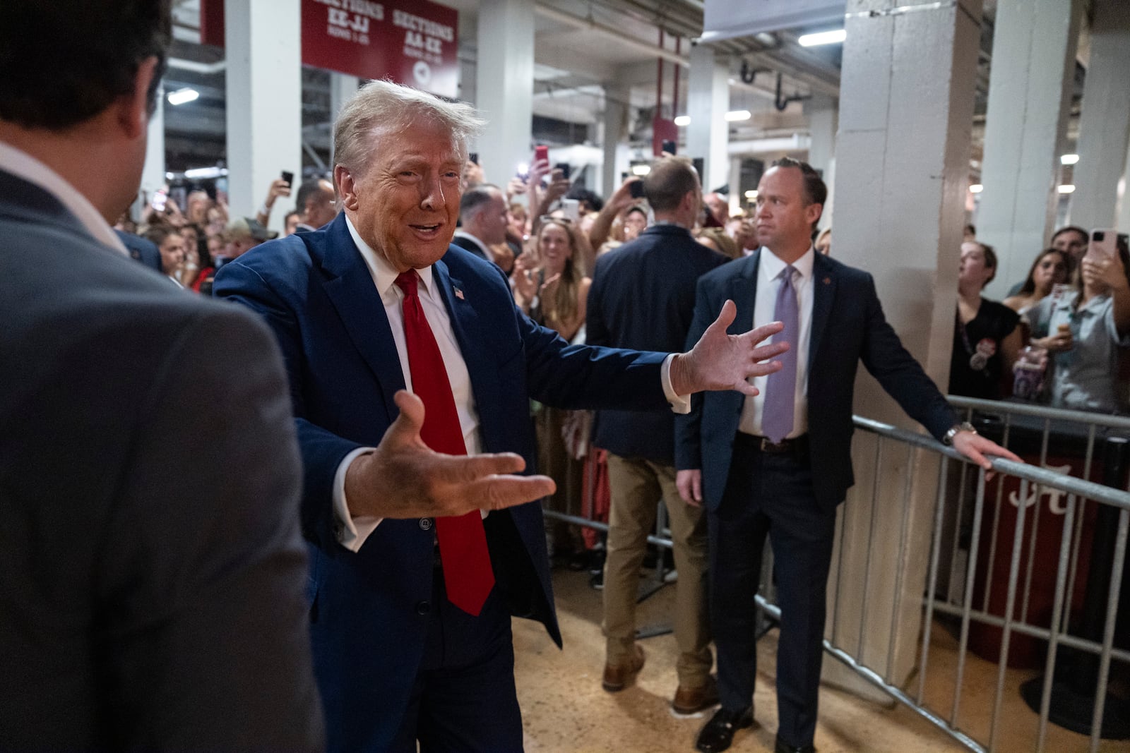 Republican presidential nominee former President Donald Trump walks to a concession stand during the Georgia vs. Alabama football game at Bryant-Denny Stadium, Saturday, Sept. 28, 2024, in Tuscaloosa, Ala. (AP Photo/Evan Vucci)