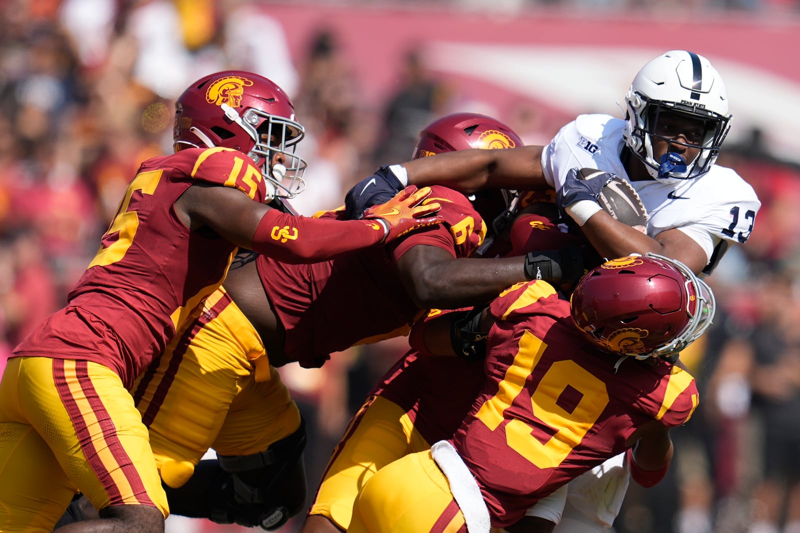 Penn State running back Kaytron Allen (13) is tackled by Southern California cornerback John Humphrey (19), defensive end Anthony Lucas (6) and safety Anthony Beavers Jr. (15) during the first half of an NCAA college football game Saturday, Oct. 12, 2024, in Los Angeles. (AP Photo/Marcio Jose Sanchez)