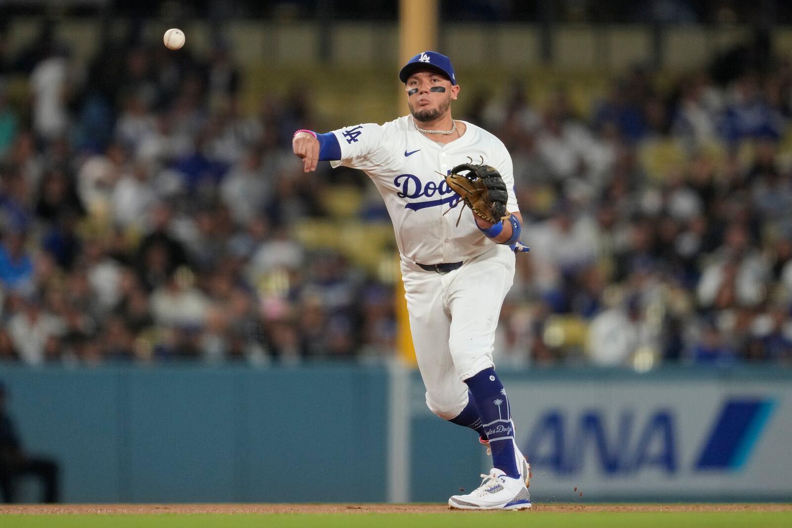 Los Angeles Dodgers shortstop Miguel Rojas throws to first to out Colorado Rockies' Brendan Rodgers during the third inning of a baseball game in Los Angeles, Friday, Sept. 20, 2024. (AP Photo/Ashley Landis)