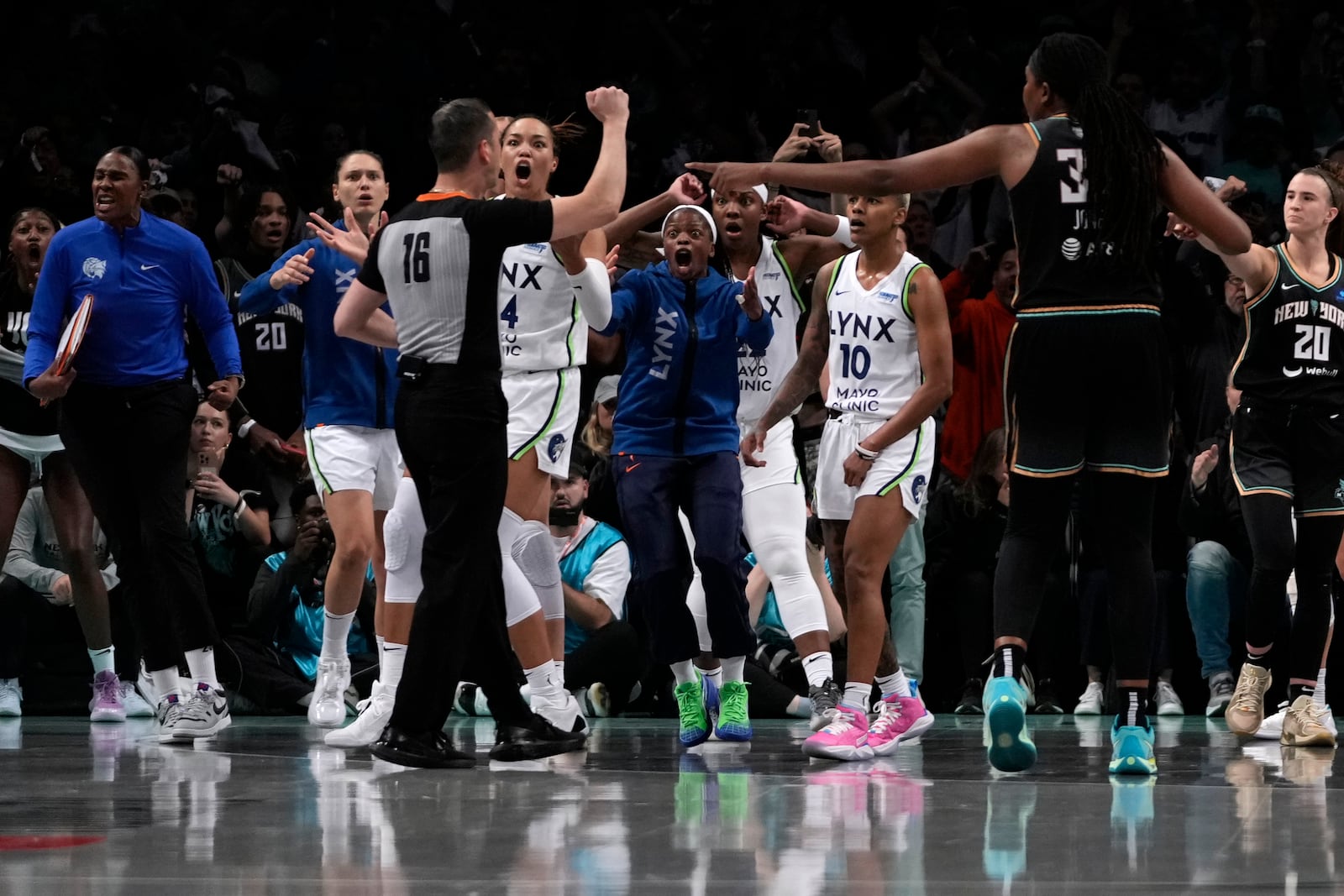 Players react after a foul is called in the last seconds of the second half in Game 1 of a WNBA basketball final playoff series between the New York Liberty and the Minnesota Lynx, Thursday, Oct. 10, 2024, in New York. (AP Photo/Pamela Smith)