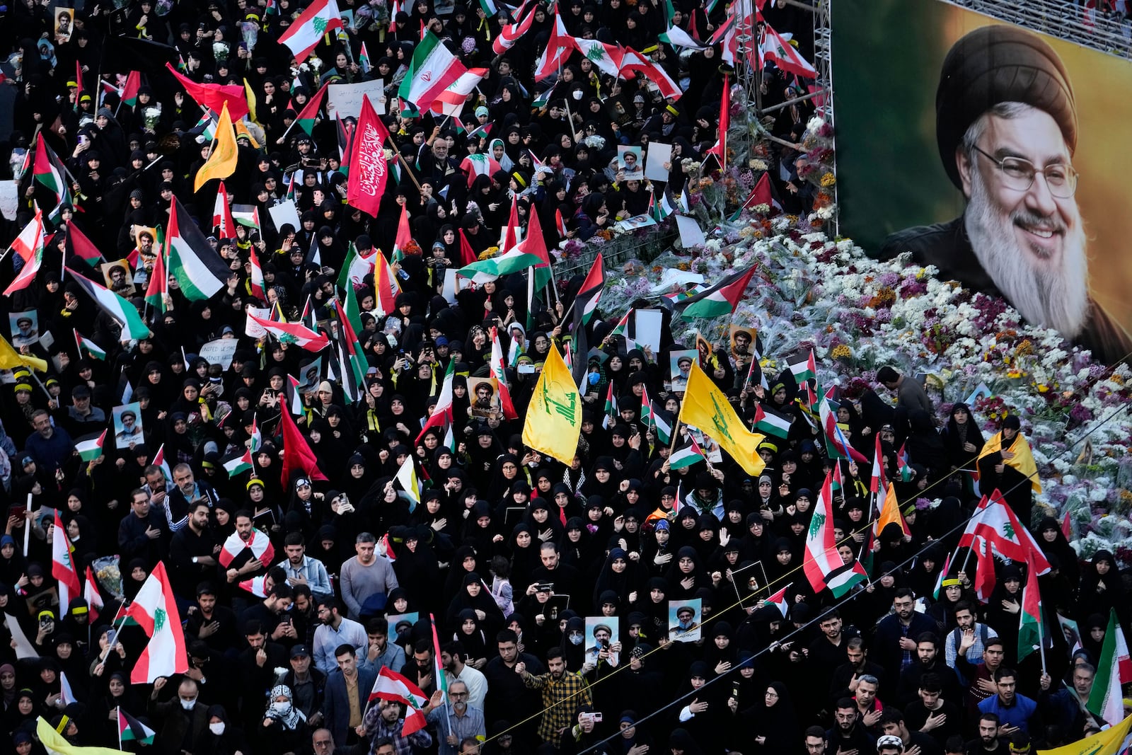 Mourners attend a rally commemorating slain Hezbollah leader Hassan Nasrallah, shown in billboard, at Felestin (Palestine) Sq. in downtown Tehran, Iran, Monday, Sept. 30, 2024. (AP Photo/Vahid Salemi)