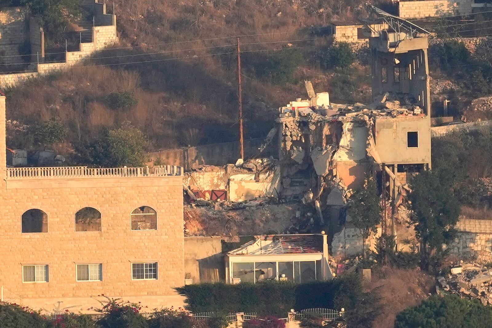 A destroyed house by an Israeli airstrike on Khiam village, as seen from Marjayoun town, south Lebanon, Tuesday, Sept. 24, 2024. (AP Photo/Hussein Malla)