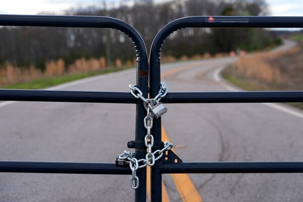 FILE - A locked gate on a closed road near the site of a planned Rivian electric truck plant is shown March 7, 2024, in Rutledge, Ga. (AP Photo/John Bazemore, File)