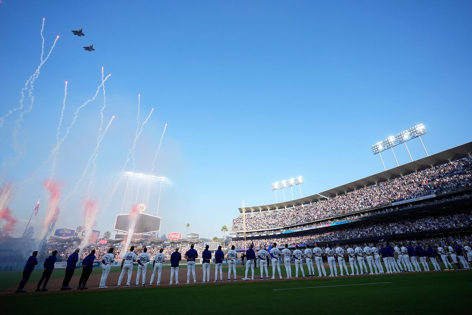 Planes fly over Dodger Stadium before Game 1 of baseball's NL Division Series between the Los Angeles Dodgers and the San Diego Padres, Saturday, Oct. 5, 2024, in Los Angeles. (AP Photo/Ashley Landis)