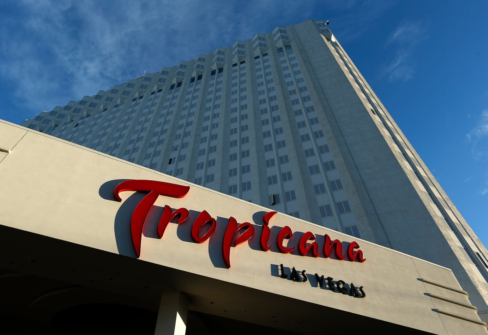 FILE - Sunlight illuminates a sign at the Tropicana hotel and casino on Aug. 4, 2015, in Las Vegas. (AP Photo/John Locher, File)