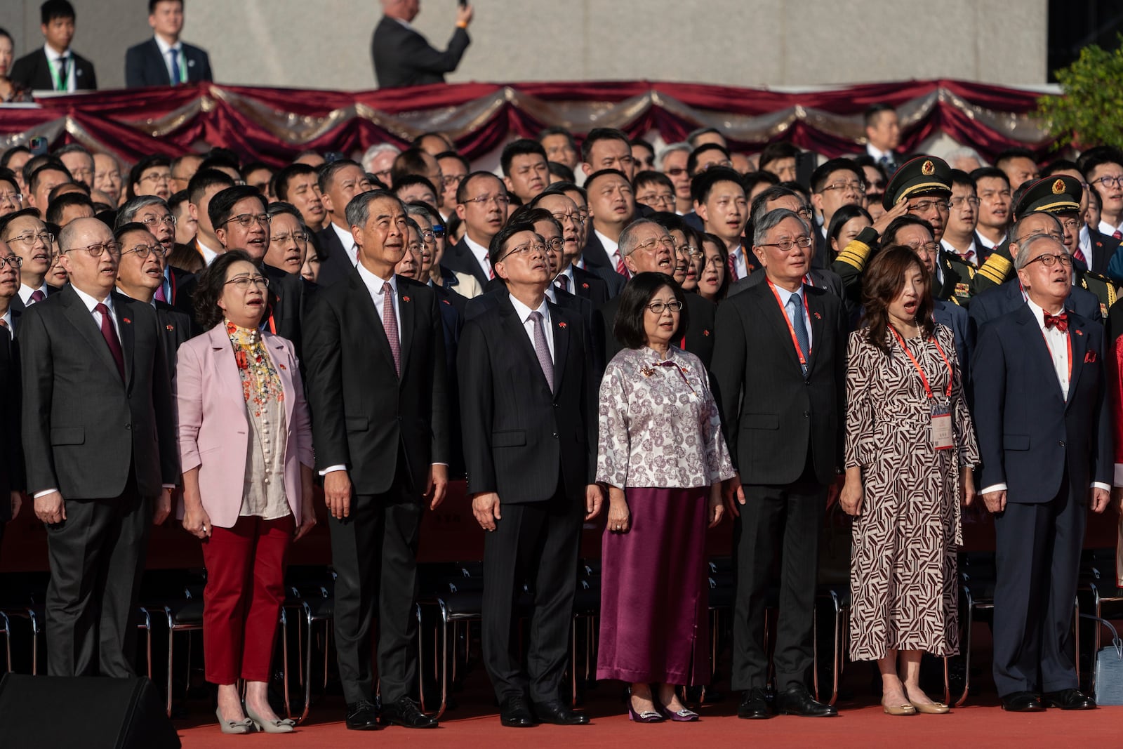 Hong Kong Chief Executive John Lee, fourth from left, and other officials attend a flag raising ceremony for the celebration of the 75th National Day of the People's Republic of China in Hong Kong, Tuesday, Oct. 1, 2024. (AP Photo/Chan Long Hei)