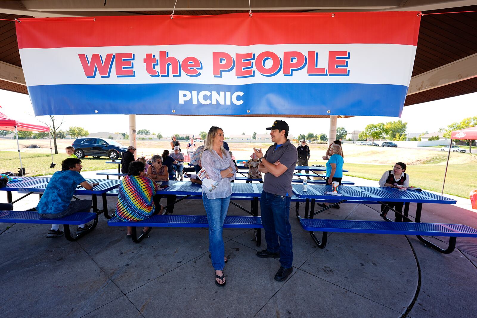 Gabe Evans, Republican candidate for the U.S. House District 8 in Colorado, talks with Annette Hayes during a campaign stop Saturday, Sept. 28, 2024, in Evans, Colo. (AP Photo/David Zalubowski)