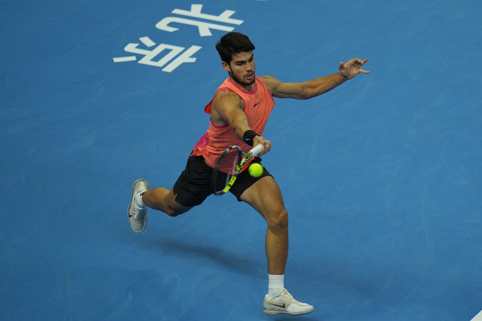 Carlos Alcaraz of Spain returns a shot from Daniil Medvedev of Russia during their men's singles semi-final match for the China Open tennis tournament held at the National Tennis Center in Beijing, Tuesday, Oct. 1, 2024. (AP Photo/Ng Han Guan)