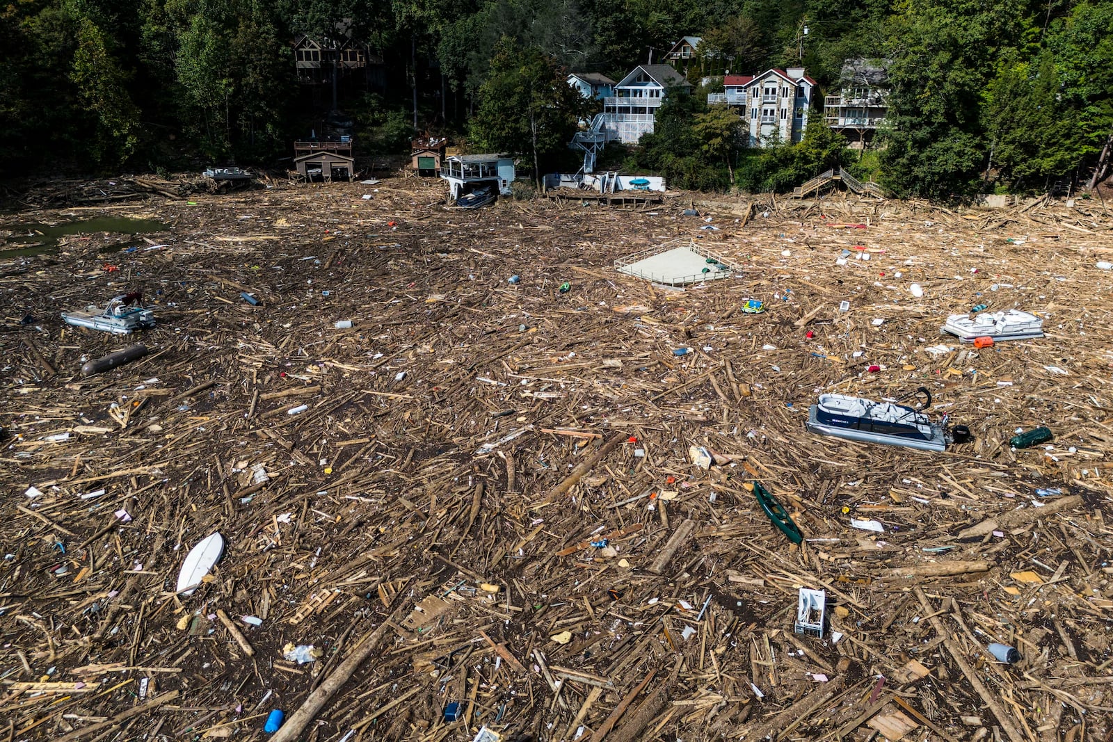 FILE - Debris is strewn on the lake in the aftermath of Hurricane Helene, Oct. 2, 2024, in Lake Lure, N.C. (AP Photo/Mike Stewart, File)