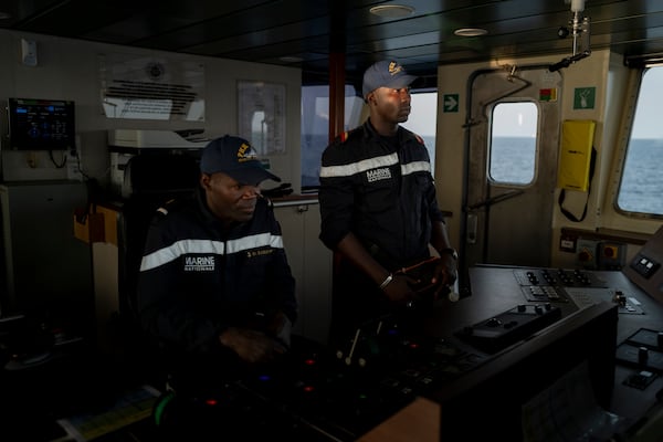 Senegalese sailors survey the sea at the offshore patrol vessel Niani during a mission to search for illegal migrant boats near the coast of Dakar, Senegal, Saturday, Nov.16, 2024. (AP Photo/Sylvain Cherkaoui)