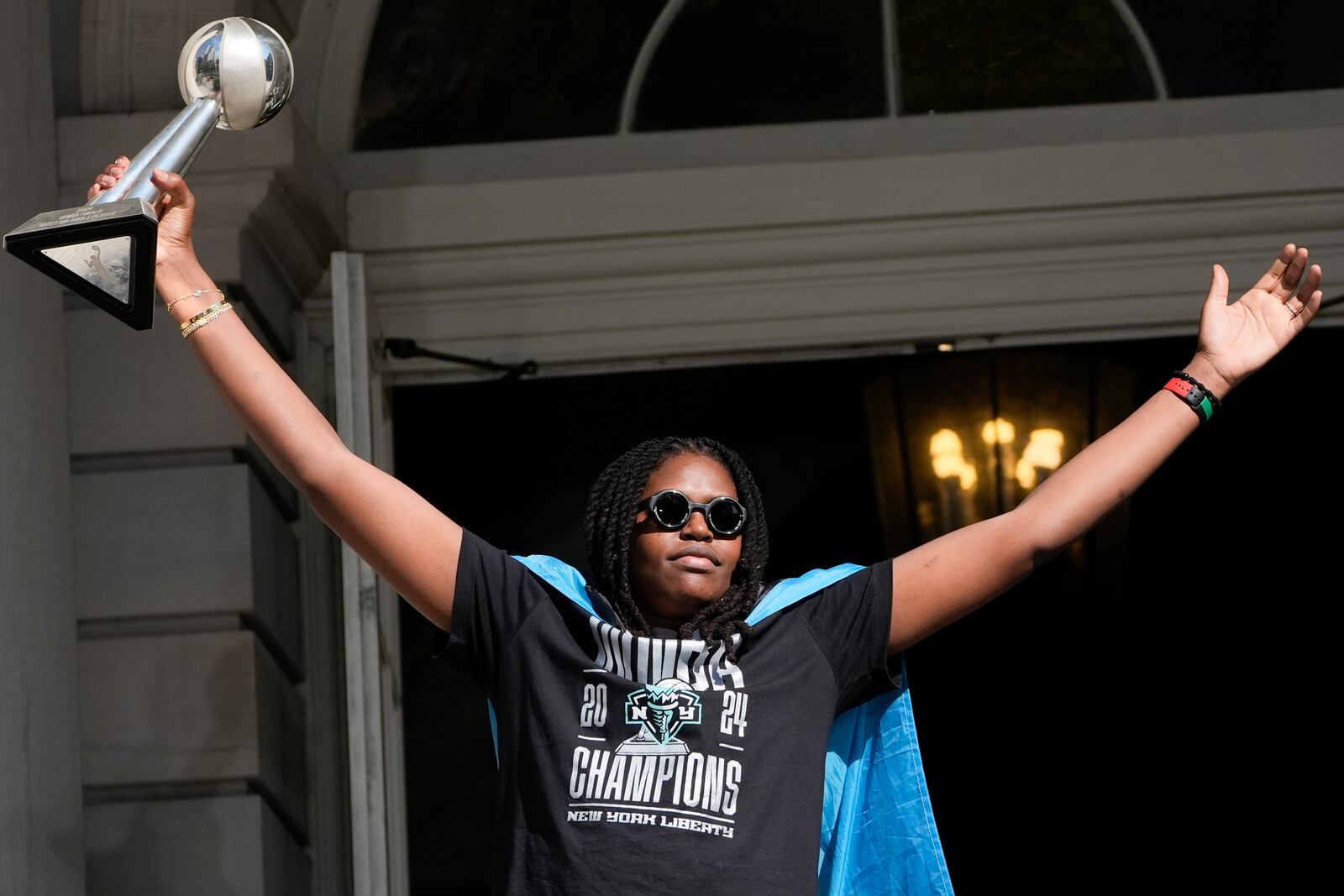 New York Liberty MVP Jonquel Jones greets the crowd as she arrives on stage during a ceremony after a parade in honor of the Liberty's WNBA basketball championship at City Hall in New York, Thursday, Oct. 24, 2024. (AP Photo/Seth Wenig)