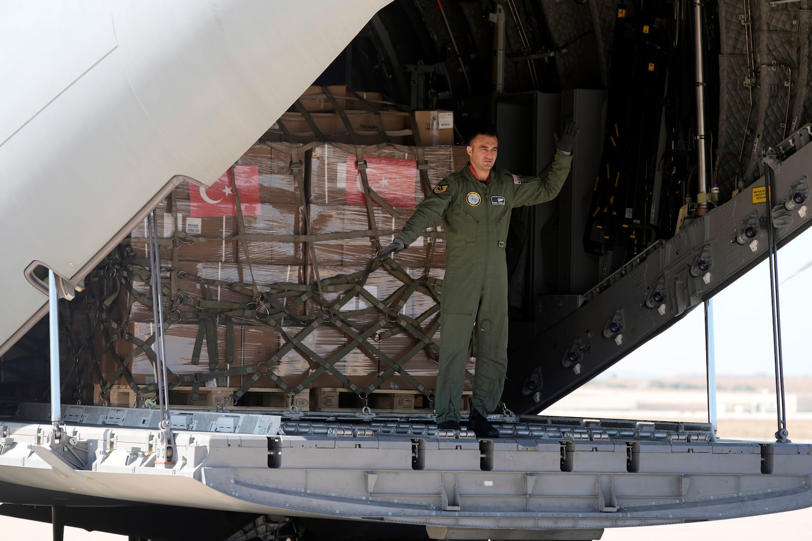 A Turkish Air Force personnel unloads medical aid boxes at Beirut airport, Wednesday, Sept. 25, 2024. (AP Photo/Bilal Hussein)