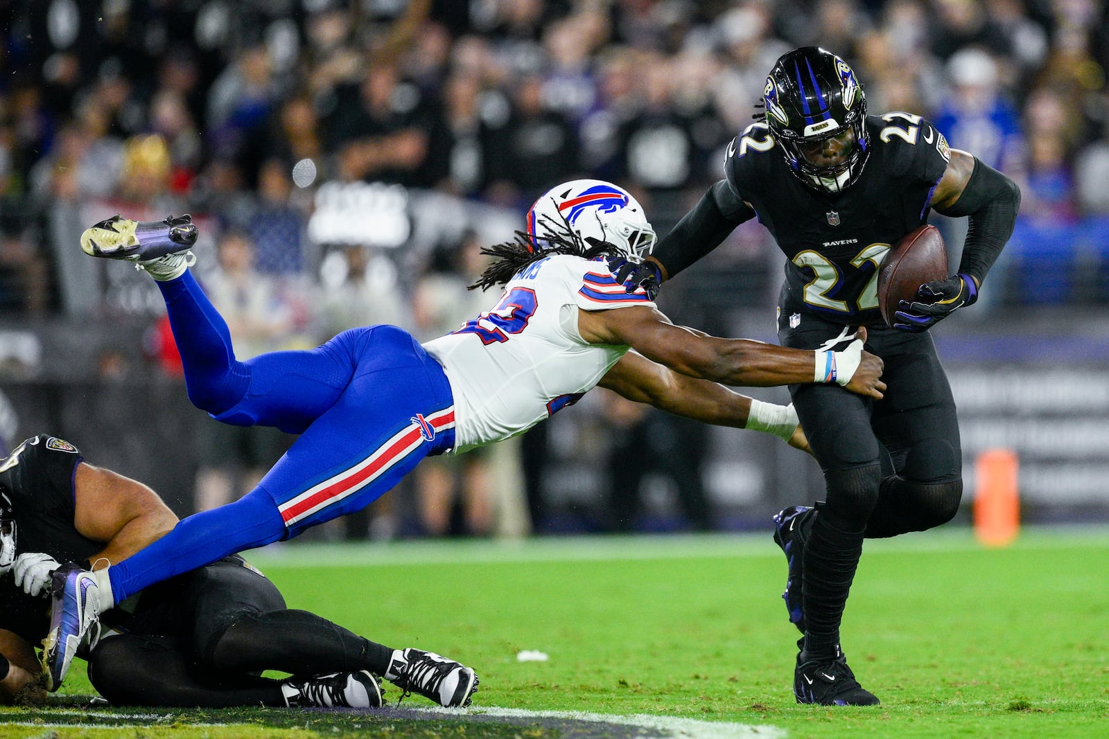 Baltimore Ravens running back Derrick Henry, right, runs with the ball as Buffalo Bills linebacker Dorian Williams tries to stop him during the first half of an NFL football game, Sunday, Sept. 29, 2024, in Baltimore. (AP Photo/Nick Wass)