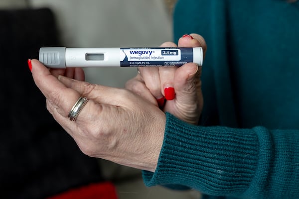 FILE - Donna Cooper holds up a dosage of Wegovy, a drug used for weight loss, at her home, March 1, 2024, in Front Royal, Va. (AP Photo/Amanda Andrade-Rhoades, File)