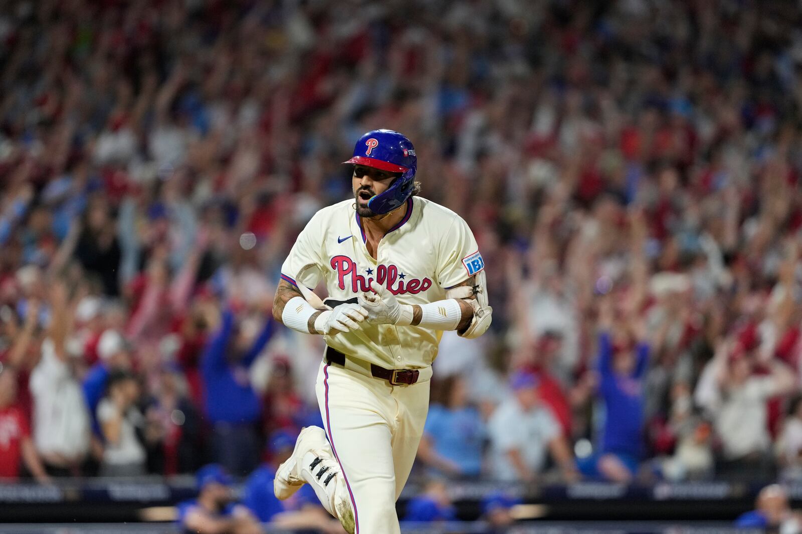 Philadelphia Phillies' Nick Castellanos reacts after hitting a one-run single against New York Mets pitcher Tylor Megill during the ninth inning to win Game 2 of a baseball NL Division Series, Sunday, Oct. 6, 2024, in Philadelphia. (AP Photo/Matt Slocum)