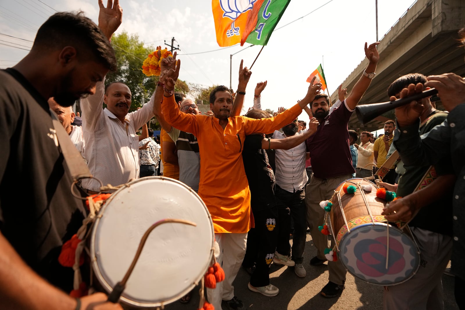 Bharatiya Janata Party (BJP) supporters dance and celebrate a party candidate's victory in Jammu, India, Tuesday, Oct.8, 2024. (AP Photo/Channi Anand)