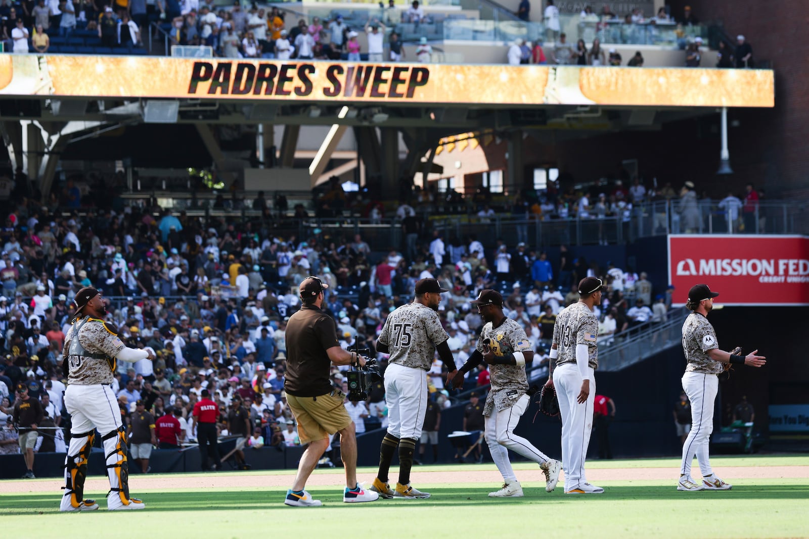 San Diego Padres' Jurickson Profar, third from right, celebrates with Robert Suarez after the team defeated the Chicago White Sox in a baseball game Sunday, Sept. 22, 2024, in San Diego. (AP Photo/Derrick Tuskan)