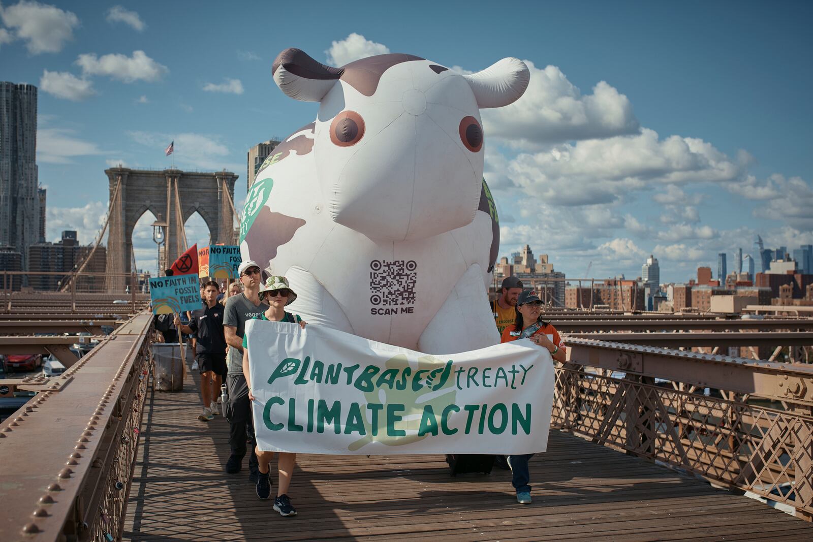 Protesters cross the Brooklyn Bridge during a Youth Climate Strike march to demand an end to the era of fossil fuels, Friday, Sept. 20, 2024, in New York. (AP Photo/Andres Kudacki)