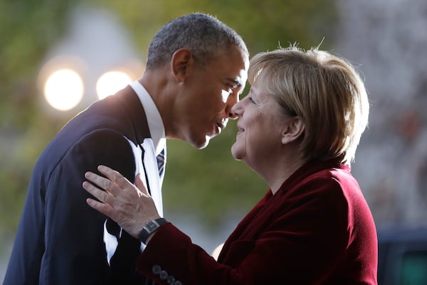 FILE - U.S. President Barack Obama, left, is welcomed by German Chancellor Angela Merkel prior to a meeting in the chancellery in Berlin, Germany, Thursday, Nov. 17, 2016. (AP Photo/Michael Sohn, File)