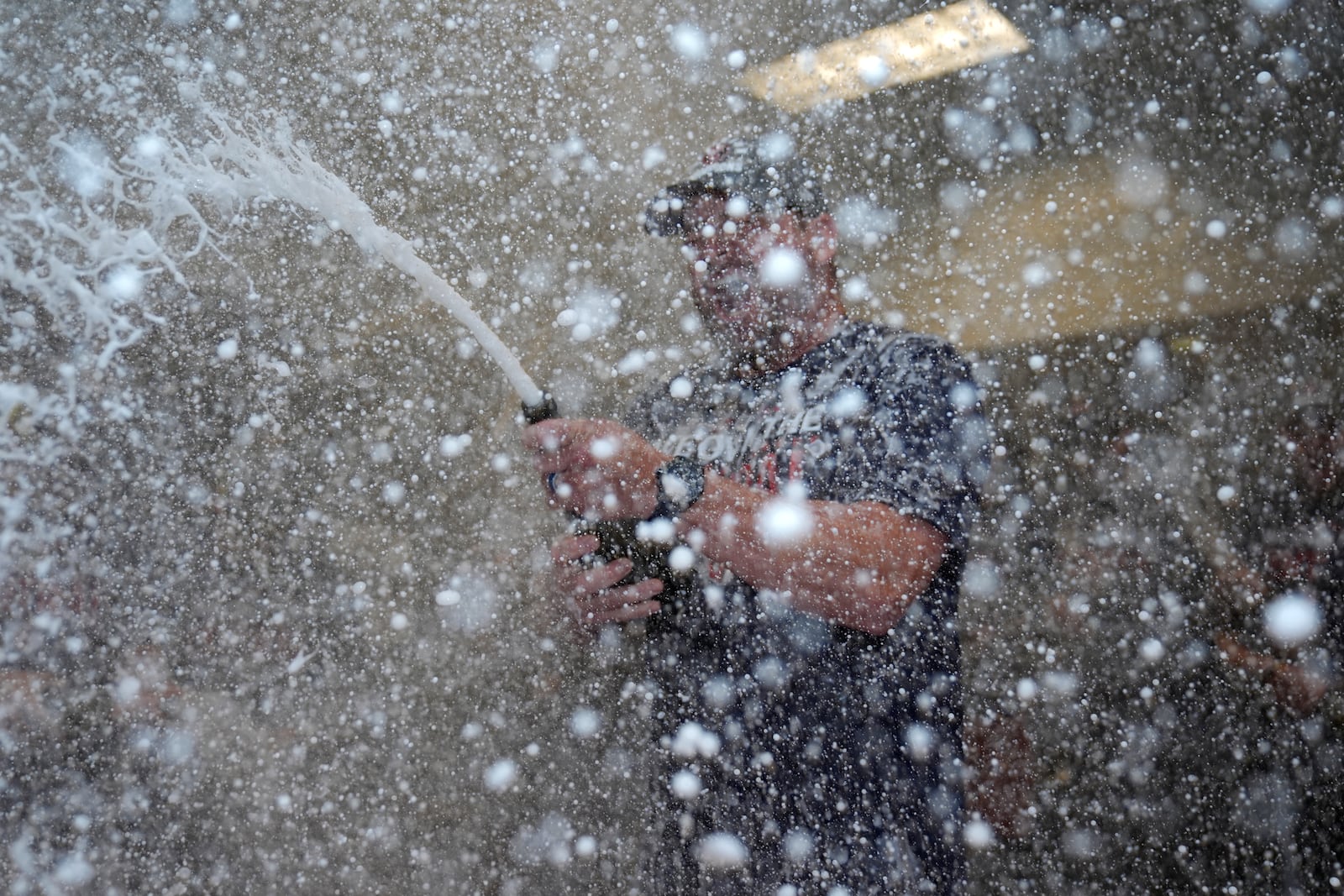 Cleveland Guardians manager Stephen Vogt celebrates in the clubhouse following a baseball game against the St. Louis Cardinals and winning the American League Central Saturday, Sept. 21, 2024, in St. Louis. (AP Photo/Jeff Roberson)