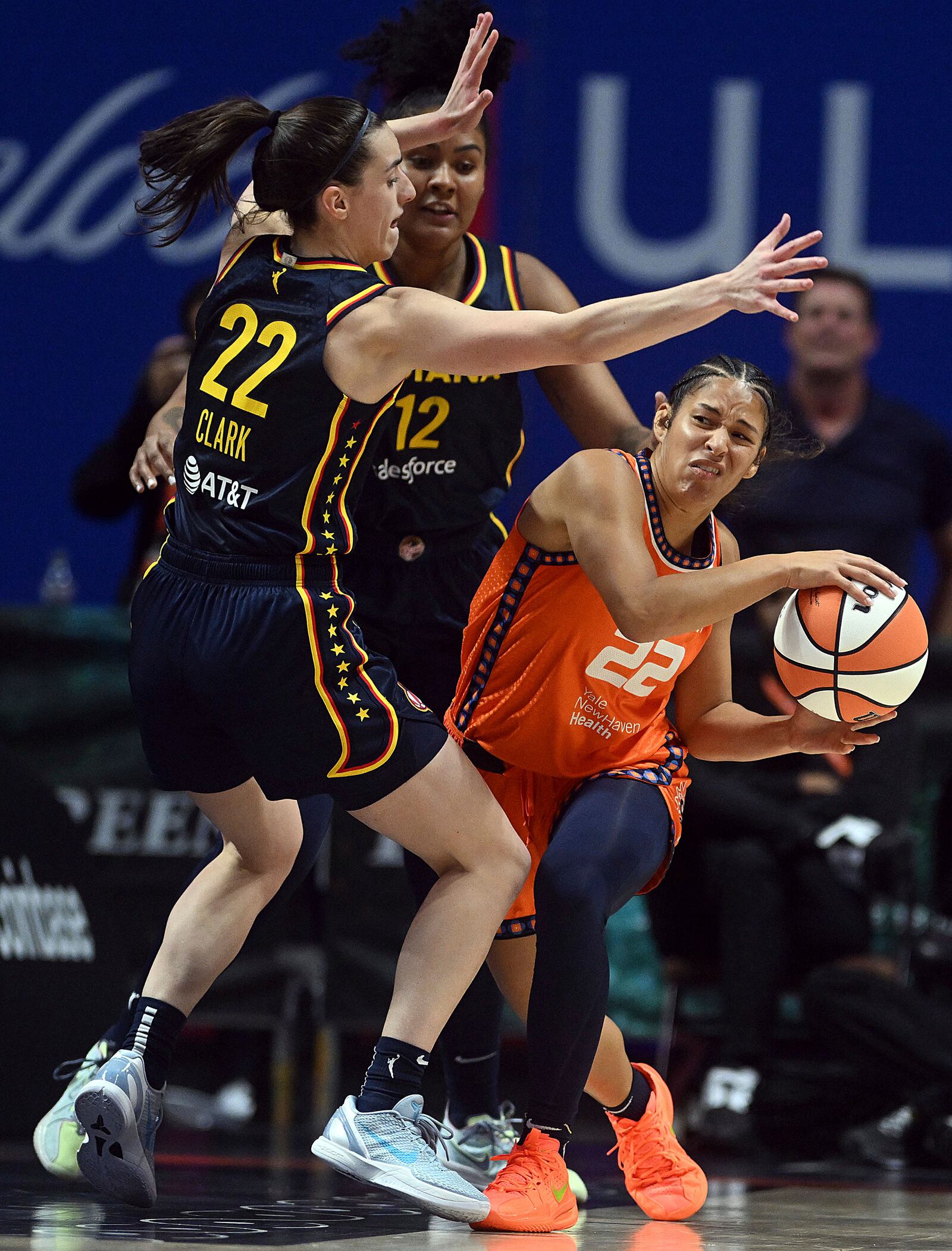 Connecticut Sun's Veronica Burton, right, is guarded by Indiana Fever's Caitlin Clark, left, and Damiris Dantas (12) during a first-round WNBA basketball playoff game at Mohegan Sun Arena, Sunday, Sept. 22, 2024. (Sarah Gordon=stnld=