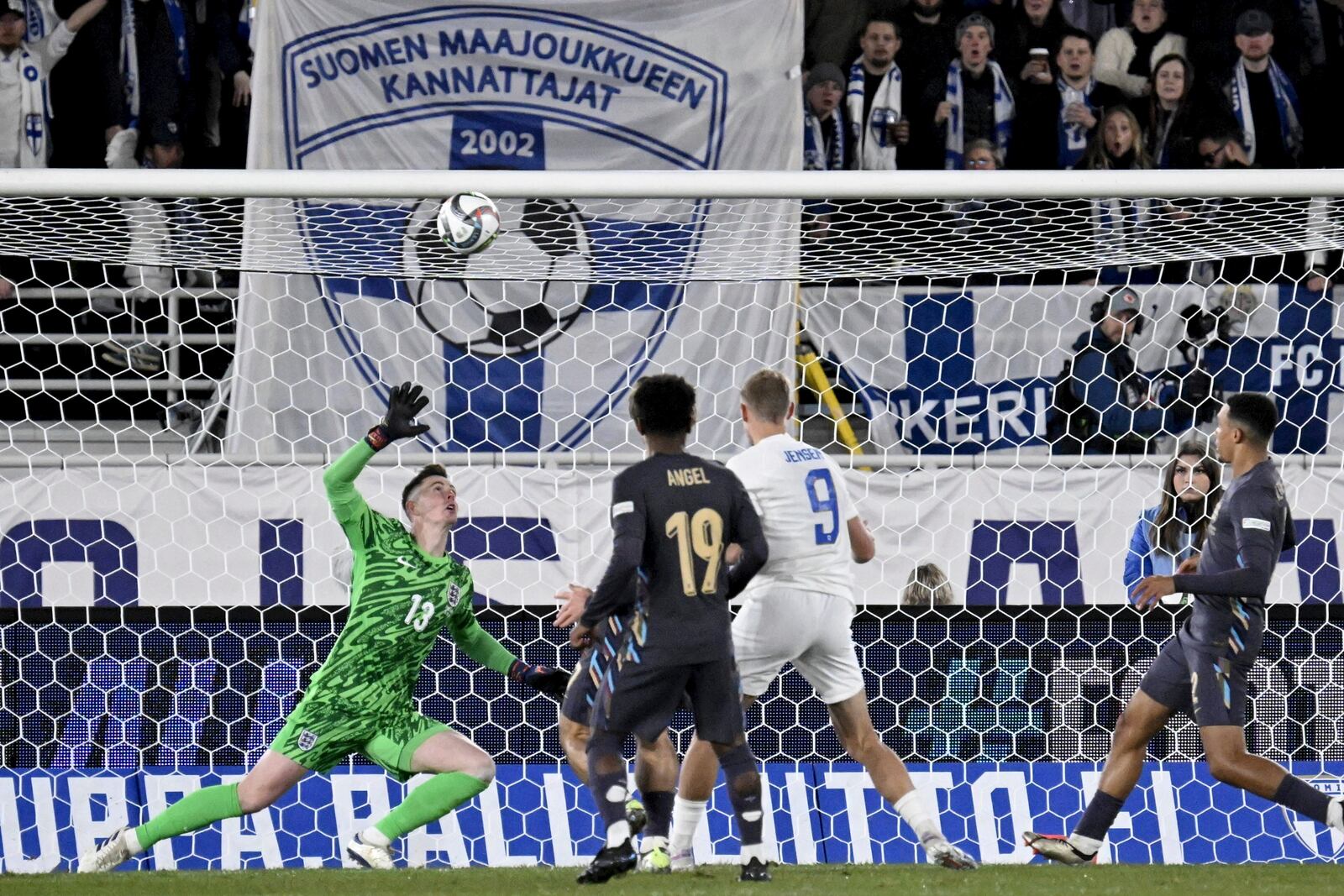 Fredrik Jensen of Finland, centre right, fails to score past goalkeeper Dean Henderson of England during the UEFA Nations League soccer match between Finland and England, at the Olympic Stadium in Helsinki, Finland, Sunday, Oct. 13, 2024. (Antti Aimo-Koivisto/Lehtikuva via AP)