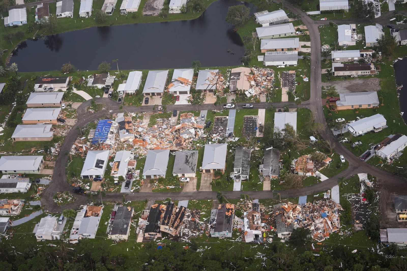 FILE - Neighborhoods with debris from tornadoes are visible in the aftermath of Hurricane Milton, Oct. 10, 2024, in Fort Pierce, Fla. (AP Photo/Gerald Herbert)