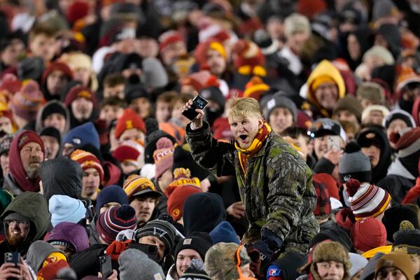 Fans celebrate on the field after an NCAA college football game between Iowa State and Kansas State, Saturday, Nov. 30, 2024, in Ames, Iowa. (AP Photo/Charlie Neibergall)