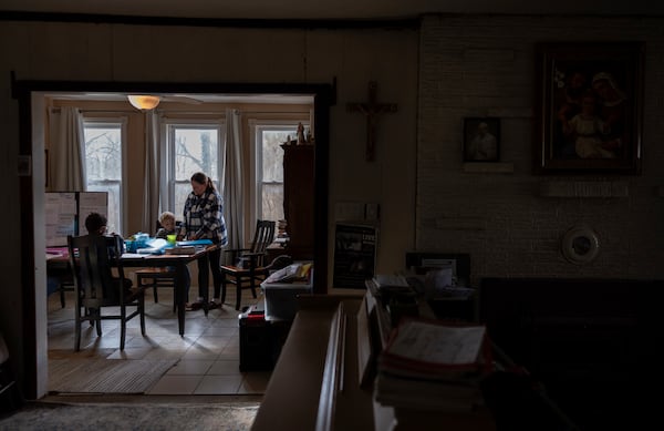 Erin Young, right, homeschools her adopted sons, Lucas, 8, left, and Isaac, 5, in the dining room of their Sunbury, Ohio, home on Tuesday, Nov. 12, 2024. (AP Photo/Carolyn Kaster)