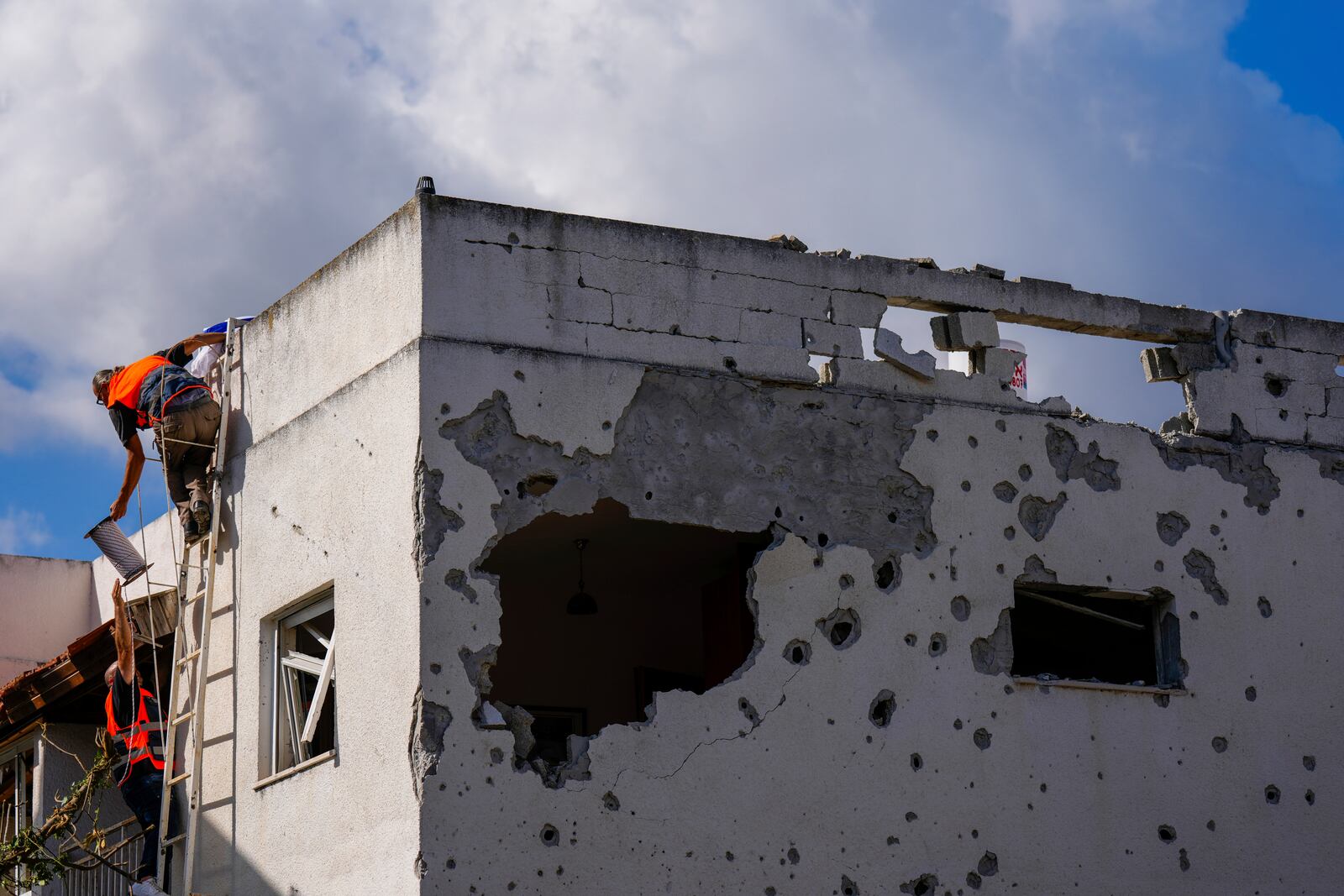 Israeli security forces work at a house hit by a rocket fired from Lebanon, in Kiryat Bialik, northern Israel, on Sunday, Sept. 22, 2024. (AP Photo//Ariel Schalit)