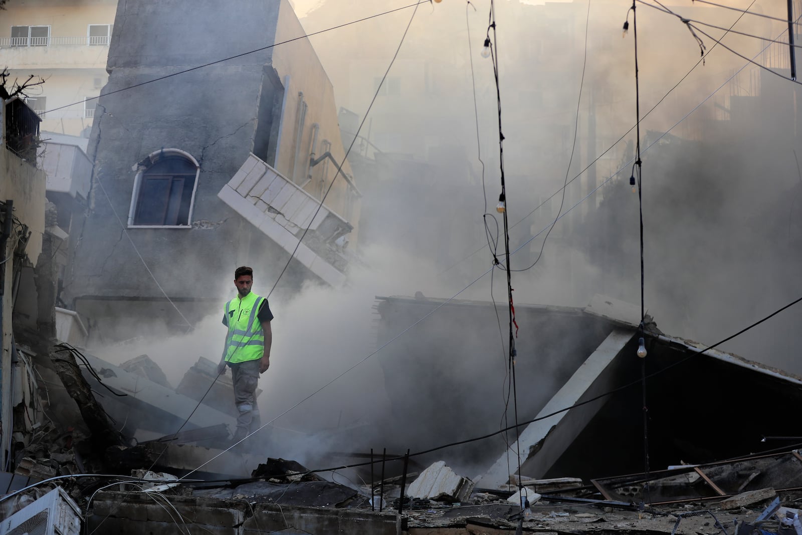 A rescue worker checks a destroyed building hit in an Israeli airstrike in Tyre, southern Lebanon, Monday, Oct. 28, 2024.(AP Photo/Mohammed Zaatari)