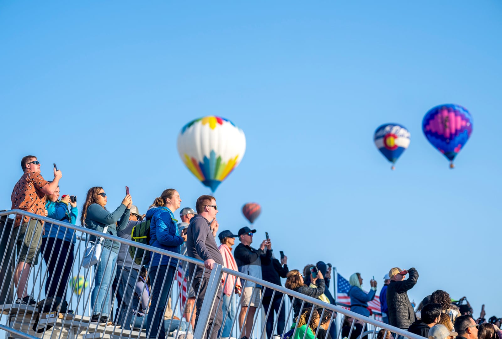 Spectators watch as hot air balloons take off during the mass ascension at the 52nd Albuquerque International Balloon Fiesta in Albuquerque, N.M., on Saturday, Oct. 5, 2024. (AP Photo/Roberto E. Rosales)