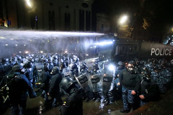 Police use a water cannon to prevent protesters pouring into the streets following Georgian Prime Minister Irakli Kobakhidze's announcement, rallying outside the parliament building in Tbilisi, Georgia, Friday, Nov. 29, 2024. (AP Photo/Zurab Tsertsvadze)