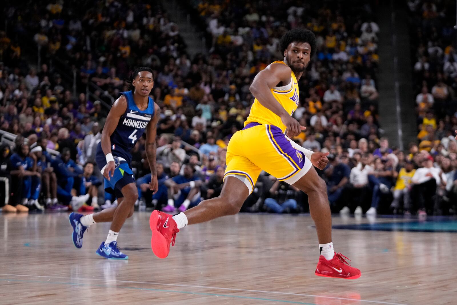 Los Angeles Lakers guard Bronny James, right, runs to the other end of the court as Minnesota Timberwolves guard Rob Dillingham watches during the first half of a preseason NBA basketball game, Friday, Oct. 4, 2024, in Palm Desert, Calif. (AP Photo/Mark J. Terrill)