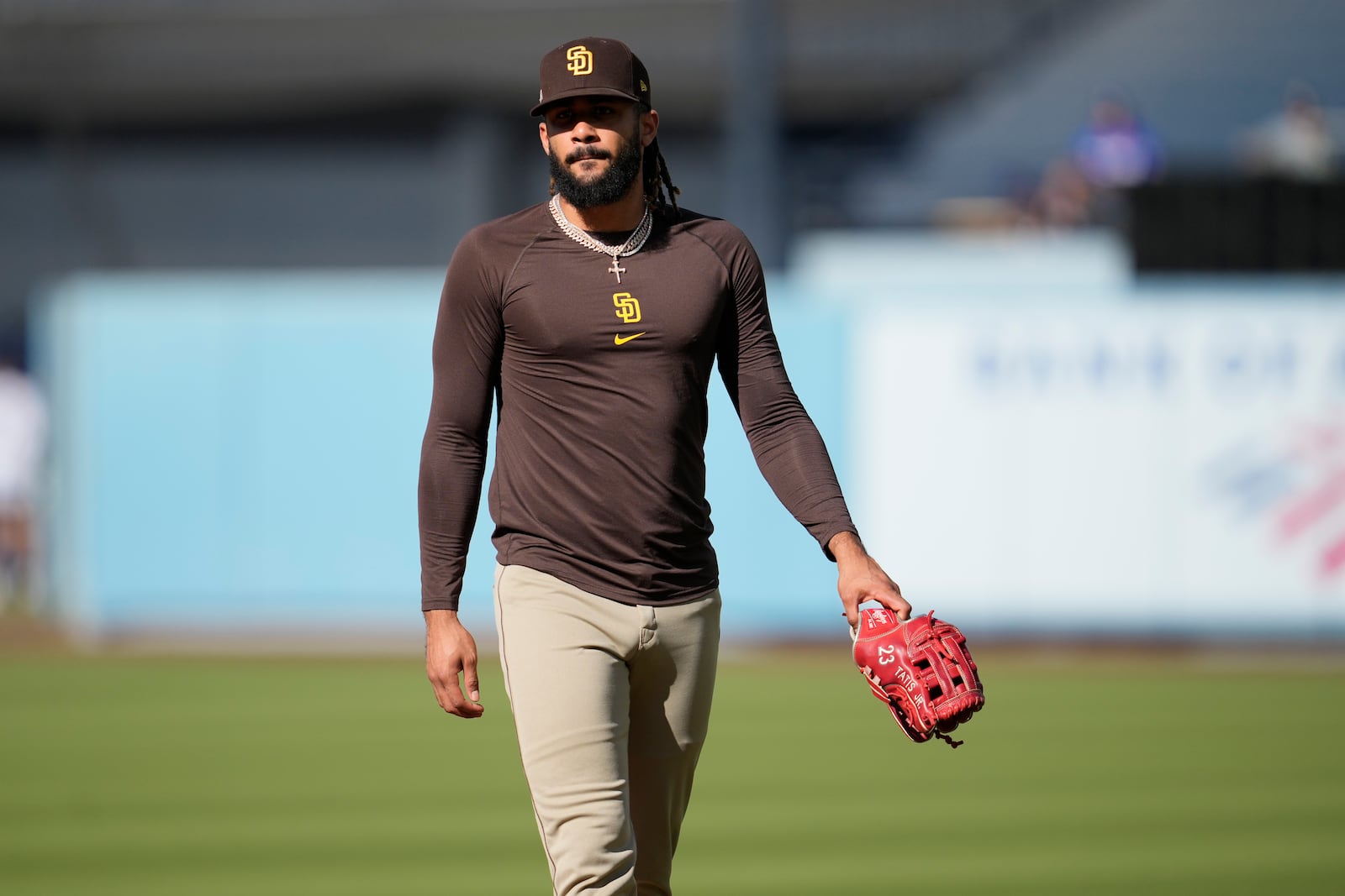 San Diego Padres' Fernando Tatis Jr. walks on the field before Game 5 of a baseball NL Division Series against the Los Angeles Dodgers, Friday, Oct. 11, 2024, in Los Angeles. (AP Photo/Ashley Landis)