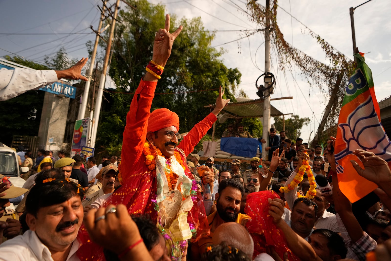 Bharatiya Janata Party (BJP) candidate Mohan lal bhagat greets supporters after victory in Jammu, India, Tuesday, Oct. 8, 2024. (AP Photo/Channi Anand)