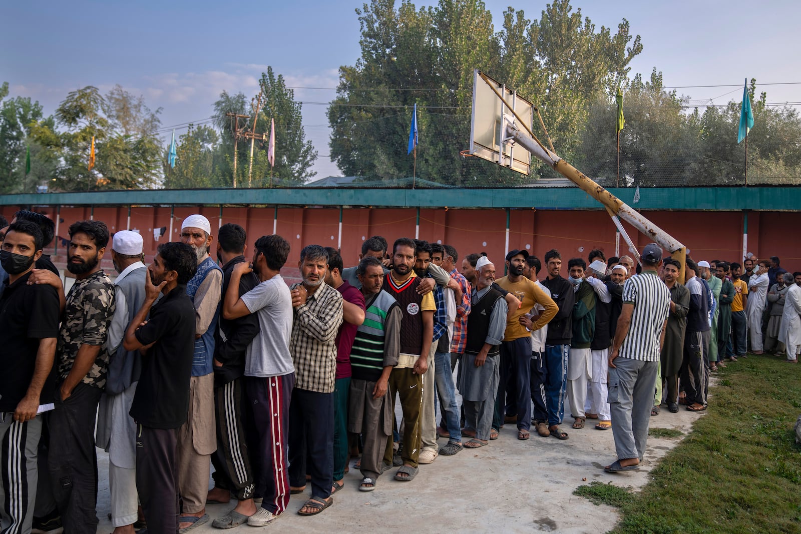 Kashmiri people queue up at a polling booth to cast their vote during the second phase of the assembly election in the outskirts of Srinagar, Indian controlled Kashmir, Wednesday, Sept. 25, 2024. (AP Photo/Dar Yasin)