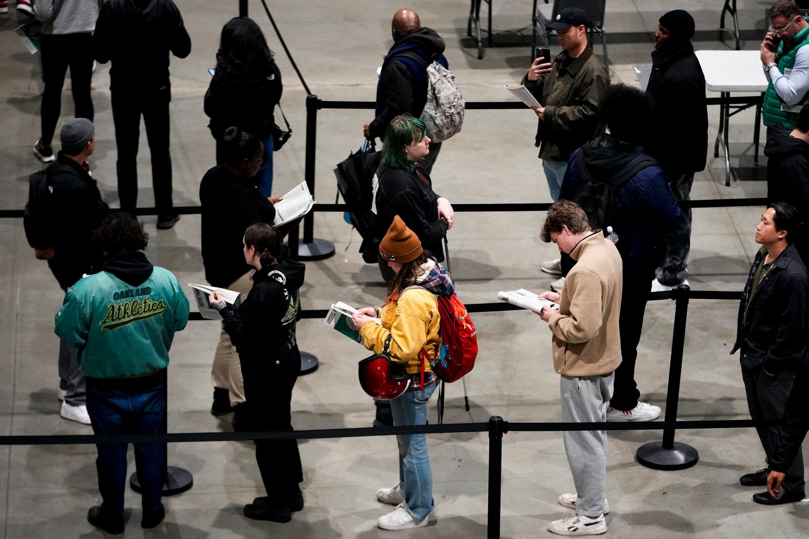 Voters wait in line to register or pick up their ballots at Lumen Field Event Center on Election Day, Tuesday, Nov. 5, 2024, in Seattle. (AP Photo/Lindsey Wasson)