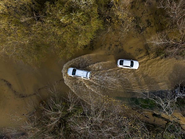 A car drives through floodwater at the Billing Aquadrome in Northamptonshire, England, Monday Nov. 25, 2024, after Storm Bert caused "devastating" flooding over the weekend. (Jordan Pettitt/PA via AP)