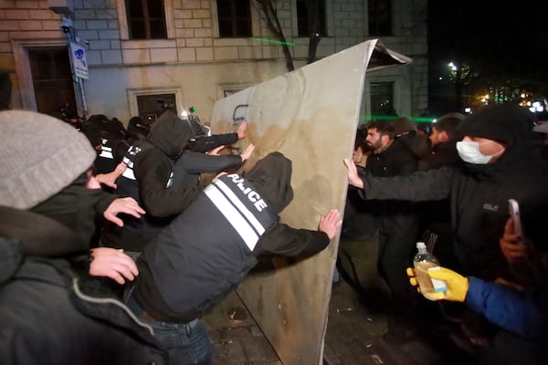 Police try to block protesters pouring into the streets following Georgian Prime Minister Irakli Kobakhidze's announcement, rallying outside the parliament building in Tbilisi, Georgia, on Friday, Nov. 29, 2024. (AP Photo/Zurab Tsertsvadze)